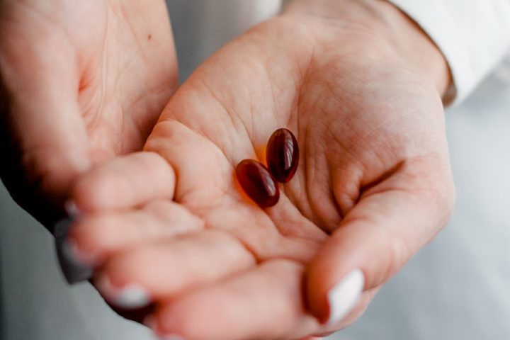 person holding brown and black round ornament