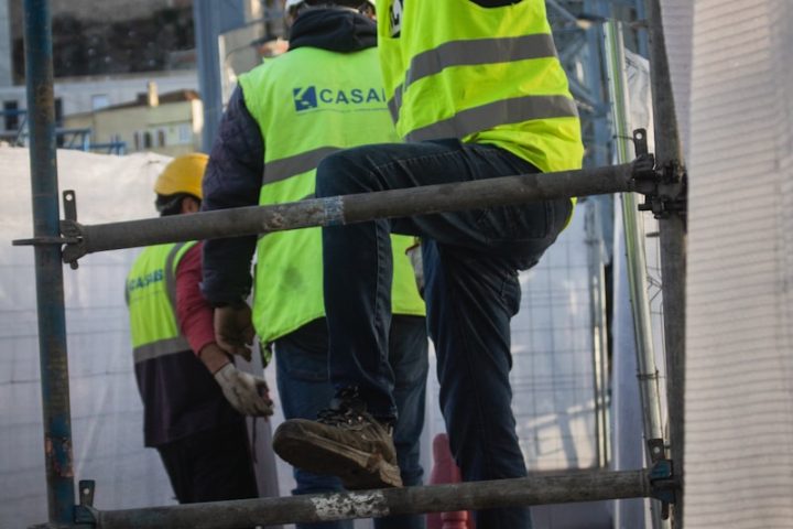 a group of men standing on top of a metal structure