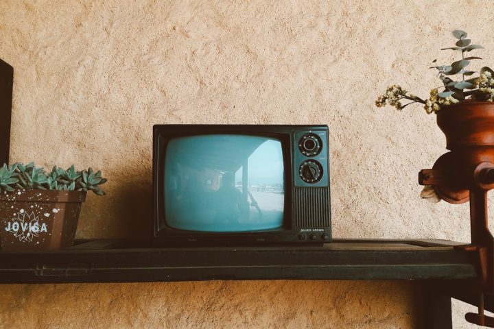 black crt tv on black wooden table
