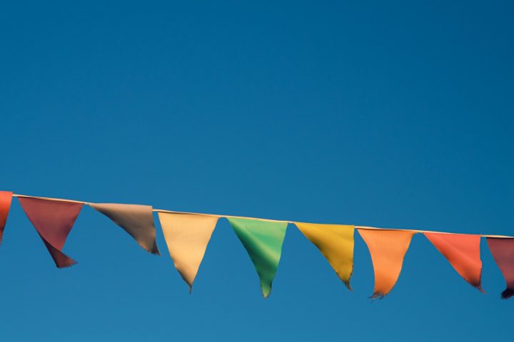 a row of colorful flags hanging from a line