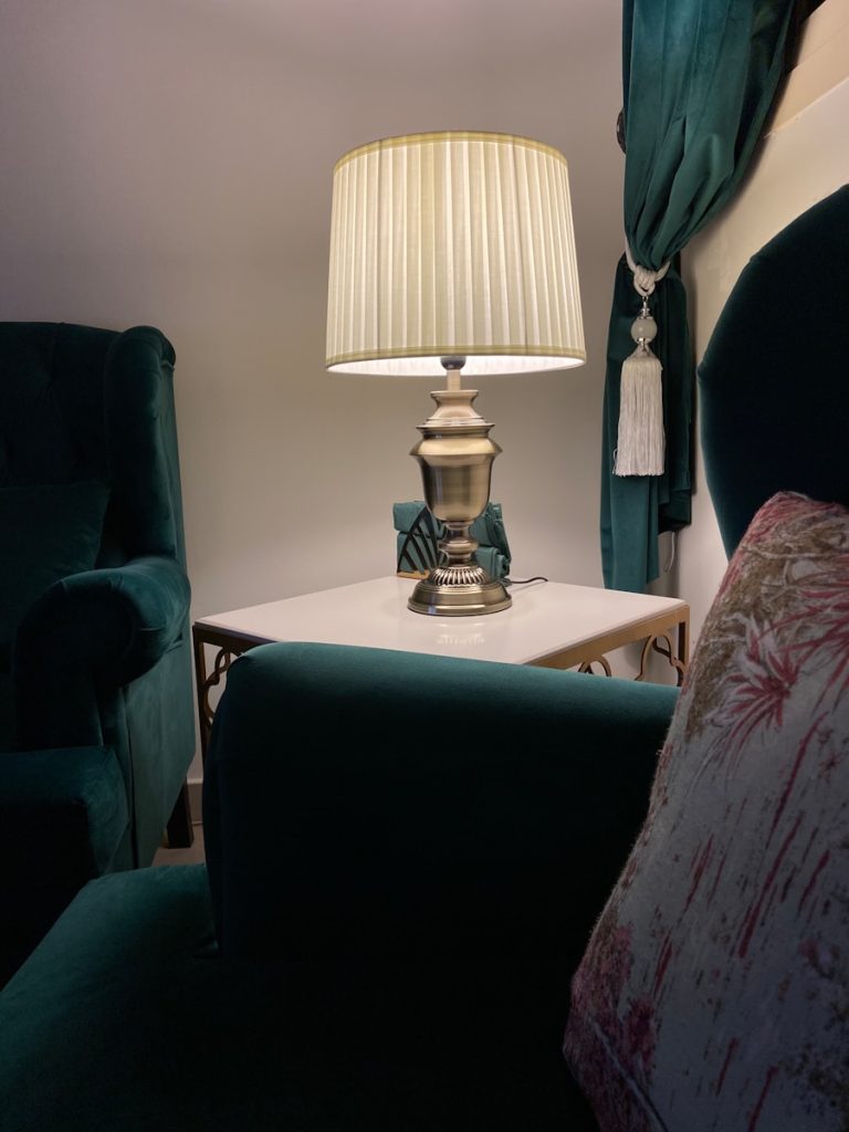 white and gold table lamp on white wooden table